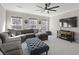 Comfortable living room features a large sectional sofa, blue ottoman, and media center at 218 Mayfield Dr, Goose Creek, SC 29445