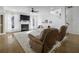 Comfortable living room with hardwood floors, plush chairs, and cozy fireplace at 218 Mayfield Dr, Goose Creek, SC 29445