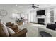 Bright living room featuring a fireplace, large area rug, and hardwood floors, flowing into the dining and kitchen areas at 218 Mayfield Dr, Goose Creek, SC 29445