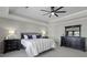 Elegant main bedroom features a tray ceiling, ceiling fan, and stylish black dresser at 218 Mayfield Dr, Goose Creek, SC 29445