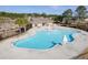 Community pool area featuring a large pool, lounge chairs, and umbrellas for sunny days at 218 Mayfield Dr, Goose Creek, SC 29445