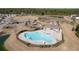 Elevated view of a community pool with lounge chairs, umbrellas, and nearby park at 218 Mayfield Dr, Goose Creek, SC 29445
