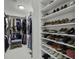 Well-organized walk-in closet featuring shoe racks, clothing rods, and a comfortable seating area at 218 Mayfield Dr, Goose Creek, SC 29445