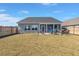 Backyard with screened in porch and grill with wooden fence, woodpile and lawn at 224 Fiddleback Dr, Summerville, SC 29486