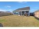 Spacious fenced backyard featuring a lawn, grilling area, and an outdoor seating area at 224 Fiddleback Dr, Summerville, SC 29486