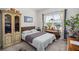 Cozy bedroom features unique armoire and natural light from the window with plants at 224 Fiddleback Dr, Summerville, SC 29486