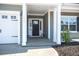 Inviting front porch featuring elegant columns, manicured landscaping, and a stylish front door for great curb appeal at 224 Fiddleback Dr, Summerville, SC 29486