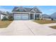 Inviting craftsman-style home with a two-car garage, well-maintained lawn, and charming architectural details at 224 Fiddleback Dr, Summerville, SC 29486