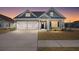 Charming home showcasing a two-car garage, landscaped yard, and craftsman-style architecture at sunset at 224 Fiddleback Dr, Summerville, SC 29486