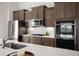 Close up of kitchen with stainless steel appliances, white countertops and dark cabinets at 224 Fiddleback Dr, Summerville, SC 29486