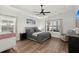 Serene main bedroom with a tray ceiling, large windows, and hardwood floors at 224 Fiddleback Dr, Summerville, SC 29486