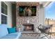Outdoor covered patio with a brick fireplace and comfortable lounge furniture at 224 Fiddleback Dr, Summerville, SC 29486