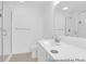Bright bathroom featuring a single sink vanity, large mirror, and a glass-enclosed shower at 224 Night Heron St # 629, Summerville, SC 29486