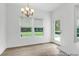 Bright dining area with large windows overlooking the backyard and modern chandelier at 224 Night Heron St # 629, Summerville, SC 29486