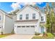 Charming two-story home featuring a two-car garage and a welcoming light blue front door at 224 Night Heron St # 629, Summerville, SC 29486