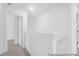 Bright white upstairs hallway with neutral carpet and painted railing at 224 Night Heron St # 629, Summerville, SC 29486