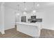 Modern kitchen with stainless steel appliances, white cabinets, and an island with pendant lighting at 224 Night Heron St # 629, Summerville, SC 29486
