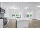 Bright kitchen with modern appliances, island with sink and pendant lighting, and views to the backyard at 224 Night Heron St # 629, Summerville, SC 29486