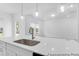 Spacious white kitchen island with a stainless steel sink and modern pendant lights at 224 Night Heron St # 629, Summerville, SC 29486