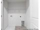 A utility room with laundry hookups and white shelving at 224 Night Heron St # 629, Summerville, SC 29486