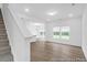 Open-concept living area with light-colored wood floors and plenty of natural light from large windows at 224 Night Heron St # 629, Summerville, SC 29486