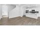 Open living space showcasing wood floors, staircase, and modern kitchen with white cabinets at 224 Night Heron St # 629, Summerville, SC 29486