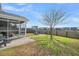 Large backyard with a screened porch, a fire pit, and a well-maintained lawn at 231 Laurel Crest Way, Summerville, SC 29486