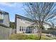 Wide shot of a large two-story house with a screened porch, patio, fire pit, and manicured lawn at 231 Laurel Crest Way, Summerville, SC 29486