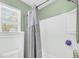 Bright bathroom featuring a shower with a gray shower curtain and white panel walls at 231 Laurel Crest Way, Summerville, SC 29486