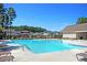 Sparkling community pool with lounge chairs, playground, grill, and clubhouse, offering residents a resort-like experience at 231 Laurel Crest Way, Summerville, SC 29486