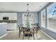 Bright dining room with a patterned table, modern chandelier, and neutral color palette at 231 Laurel Crest Way, Summerville, SC 29486