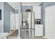 Stainless steel refrigerator in kitchen with white cabinets and modern tile backsplash at 231 Laurel Crest Way, Summerville, SC 29486