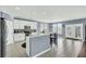 Bright kitchen with white cabinets, stainless steel appliances, quartz countertops, and a breakfast bar at 231 Laurel Crest Way, Summerville, SC 29486