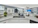 Modern kitchen sink with white cabinetry and countertops, offering a view into the living area at 231 Laurel Crest Way, Summerville, SC 29486