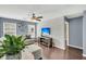 Comfortable living room with hardwood floors, bright windows, ceiling fan, and a white shiplap wall at 231 Laurel Crest Way, Summerville, SC 29486