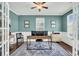 Well-lit office with teal walls, white trim, French doors, and a modern desk setup at 231 Laurel Crest Way, Summerville, SC 29486
