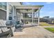 Inviting screened porch with seating, ceiling fan, and access to the backyard and a built in fire pit at 231 Laurel Crest Way, Summerville, SC 29486