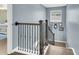 Staircase landing featuring hardwood floors, decorative wrought iron railings, and neutral paint at 231 Laurel Crest Way, Summerville, SC 29486
