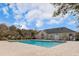 Well-maintained community pool with clear blue water, a spacious deck, and a nearby community building at 2494 Etiwan Ave # 12J, Charleston, SC 29414