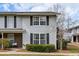Charming townhome featuring vinyl siding, black shutters, and mature landscaping enhancing its curb appeal at 2494 Etiwan Ave # 12J, Charleston, SC 29414