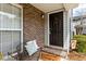 Inviting front entrance with a brick accent wall, a decorative 'Welcome Home' mat, and a cozy seating area at 2494 Etiwan Ave # 12J, Charleston, SC 29414