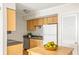 Compact kitchen featuring white appliances, wooden cabinets, and a functional layout at 2494 Etiwan Ave # 12J, Charleston, SC 29414