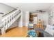 Bright living room boasts wood floors, stairs, and open layout to a kitchen with a breakfast nook and island at 2494 Etiwan Ave # 12J, Charleston, SC 29414