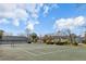 Well-maintained community tennis court with green surface, surrounded by mature trees and lush landscaping at 2494 Etiwan Ave # 12J, Charleston, SC 29414