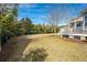 Backyard featuring green grass, trees and shrubs, and a back porch with white railings at 2972 Riverwood Dr, Mount Pleasant, SC 29466