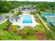 Aerial view of the community pool and tennis courts surrounded by lush landscaping and green space at 2972 Riverwood Dr, Mount Pleasant, SC 29466