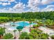 Aerial view of the neighborhood pool featuring a splash pad, palm trees, landscaping, and a waterslide at 2972 Riverwood Dr, Mount Pleasant, SC 29466