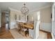 Elegant dining room with modern chandelier, wood table, chairs and views into other rooms at 2972 Riverwood Dr, Mount Pleasant, SC 29466
