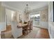 Bright dining room with wood table, chairs, chandelier, and large windows allowing natural light at 2972 Riverwood Dr, Mount Pleasant, SC 29466
