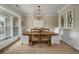 Elegant dining room with modern chandelier, wood table, and large windows allowing natural light at 2972 Riverwood Dr, Mount Pleasant, SC 29466